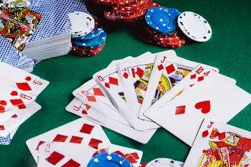 A dramatic shot of winning sevens landing on a slot reel surrounded by shining gold coins, symbolizing big wins.
